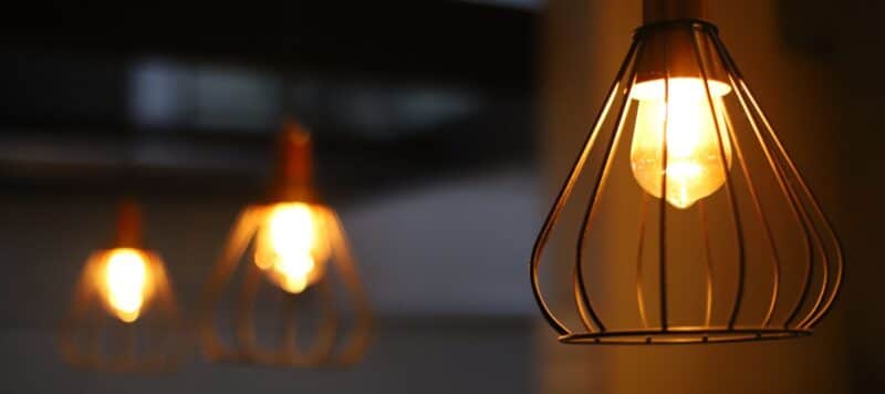 close up of outdoor string light fixtures turned on in the evening