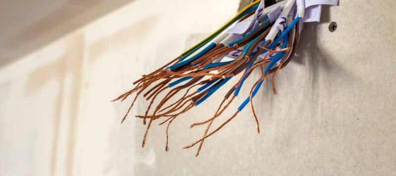 closeup of electrical wires hanging out of a socket